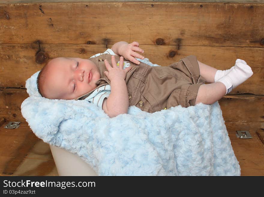 Beautiful newborn baby boy sleeping on a soft blanket. Beautiful newborn baby boy sleeping on a soft blanket