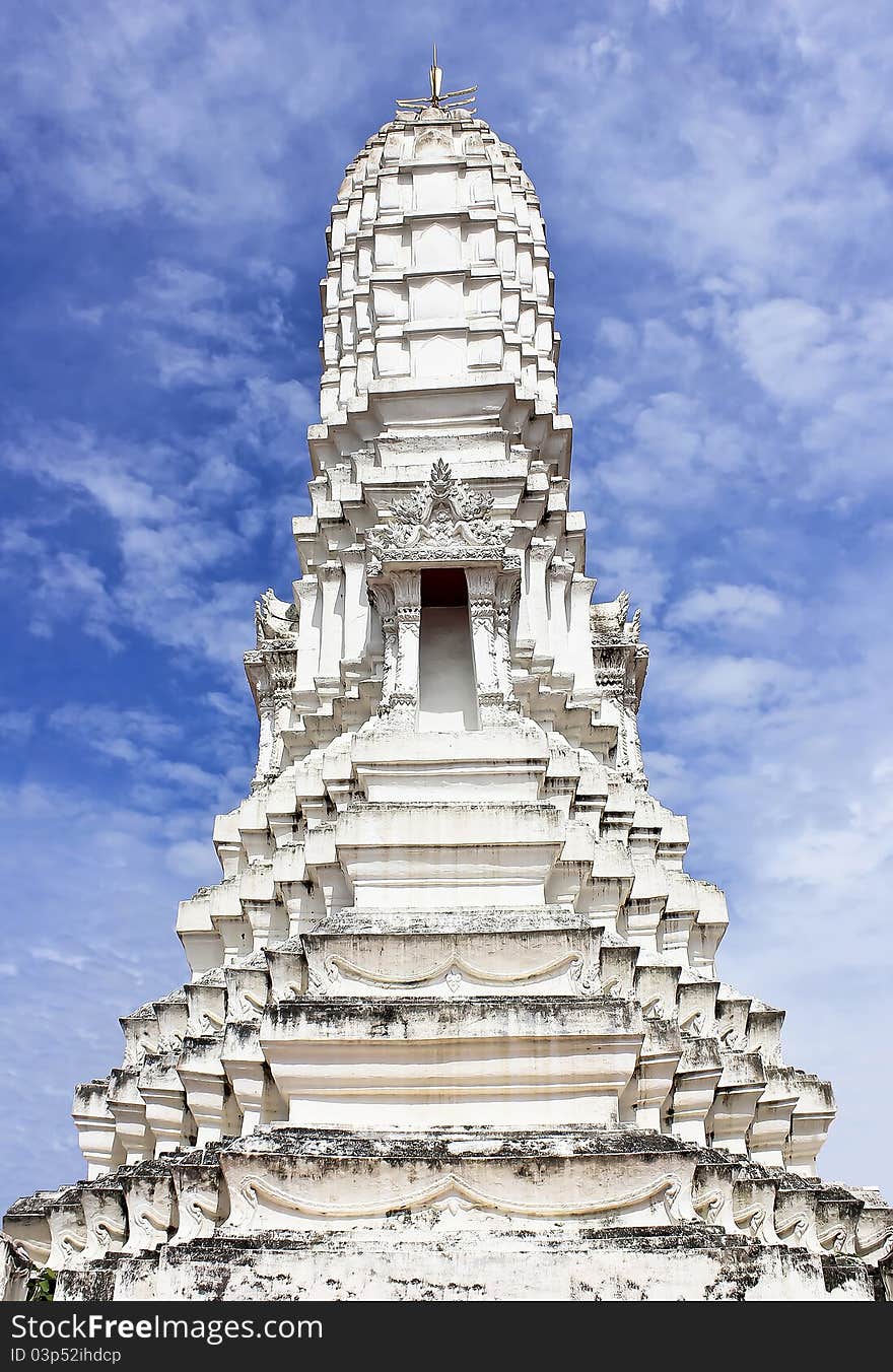 A graceful majestic white prang on blue sky background, Samut Songkhram Province, Thailand. A graceful majestic white prang on blue sky background, Samut Songkhram Province, Thailand