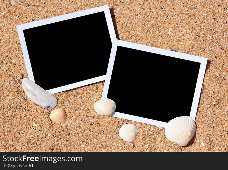 Sea shells with photos on sand background. Traveling to the sea concept. Sea shells with photos on sand background. Traveling to the sea concept.