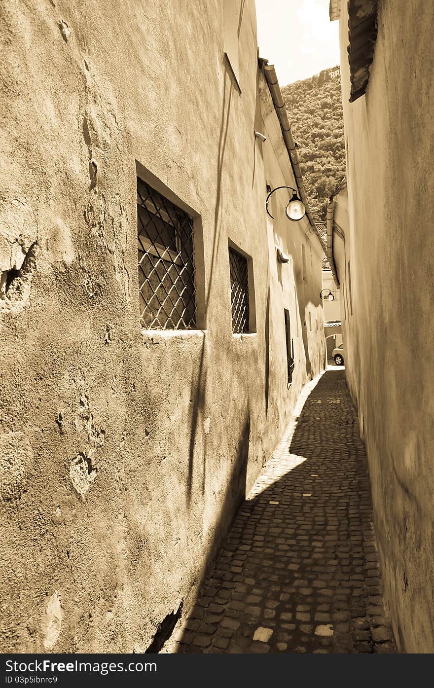 Narrow street the city of Brasov Romania. The narrowest street in Europe. Medieval street in Romania. Narrow street the city of Brasov Romania. The narrowest street in Europe. Medieval street in Romania