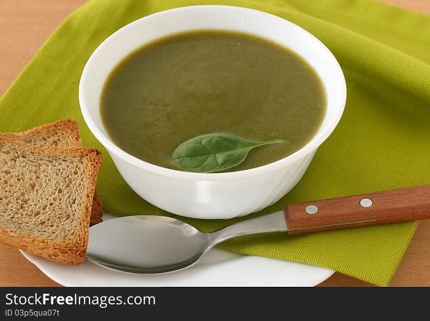 Spinach soup in a bowl with toast. Spinach soup in a bowl with toast