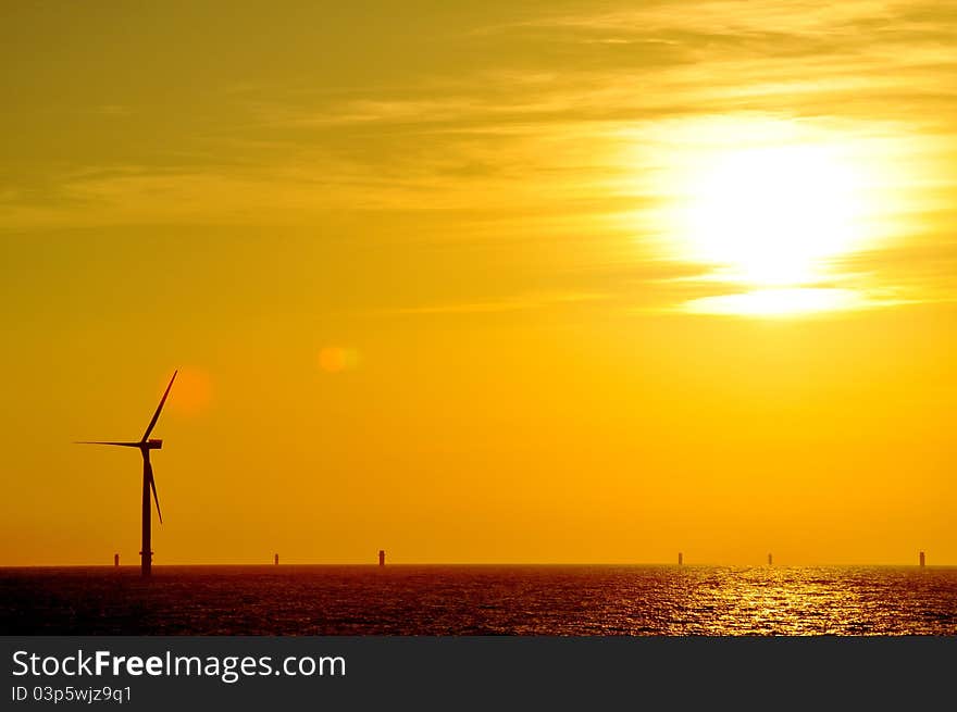 Sunset taken from Greater Gabbard Offshore Wind farm with complete turbine in foreground and part complete in background. Sunset taken from Greater Gabbard Offshore Wind farm with complete turbine in foreground and part complete in background