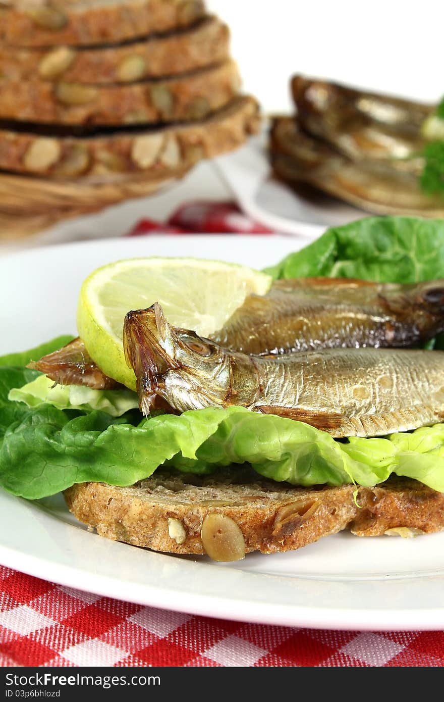 Smoked sprats on a slice of bread