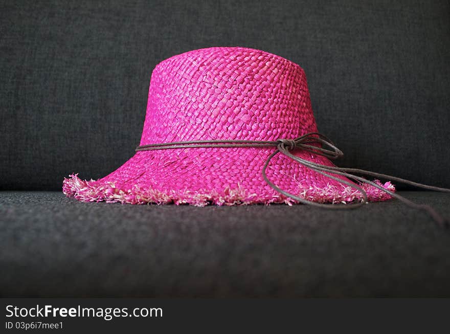 Pink beach hat, made of straw.