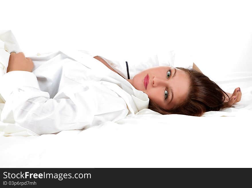 Beautiful girl lying on the snowy bed