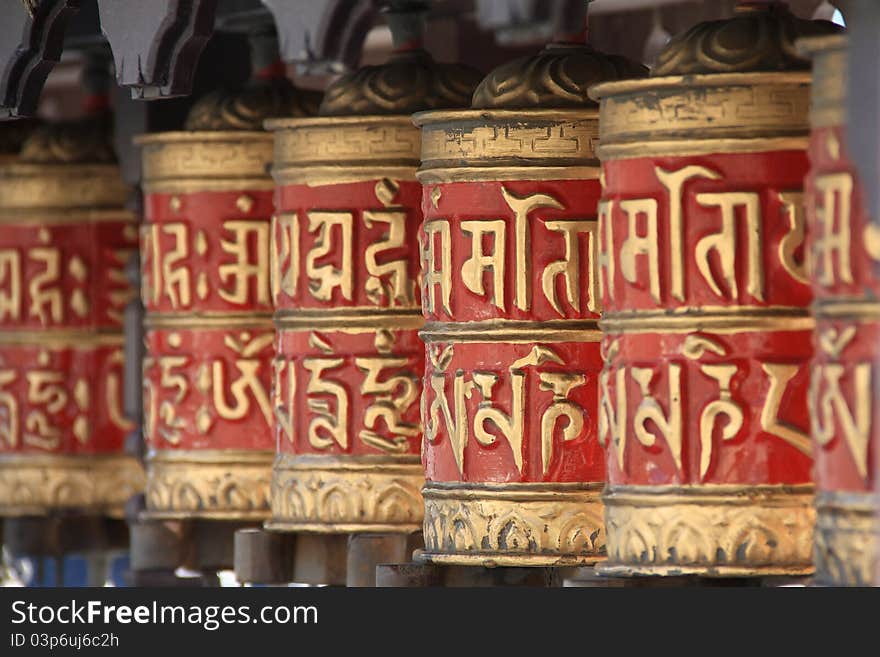 A row of buddhist prayer wheels used in tibetian buddhism.