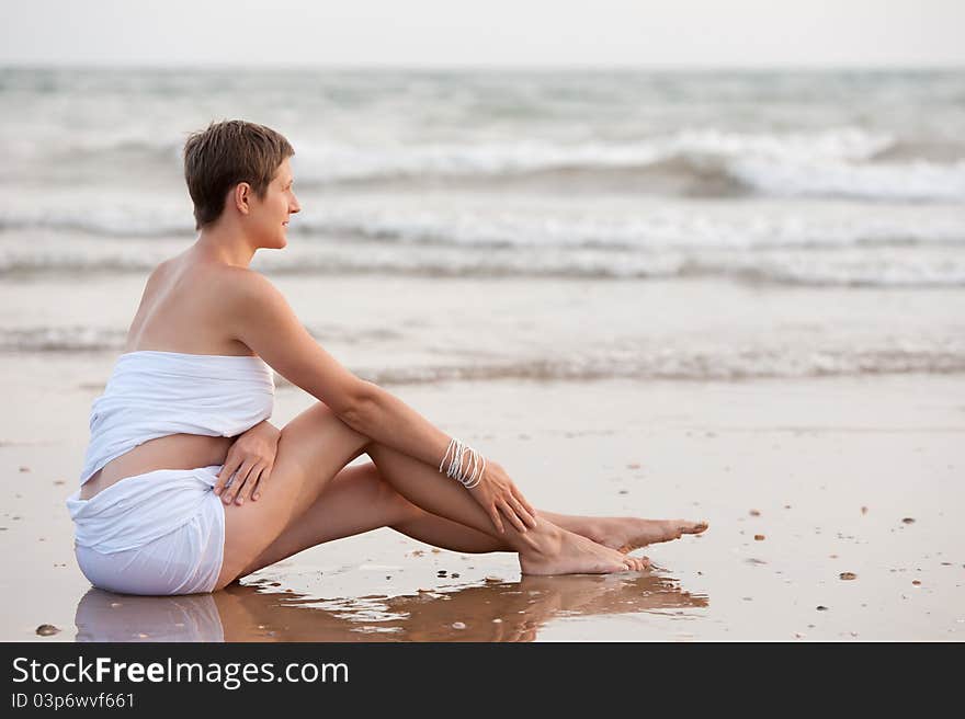 Woman Seating On The Beach