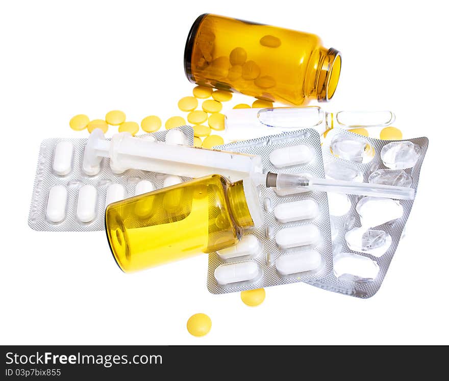 Pills and a syringe on a white background