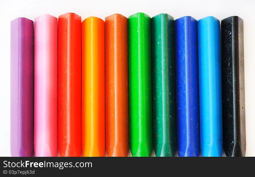 Collection of colored chalks on a white background