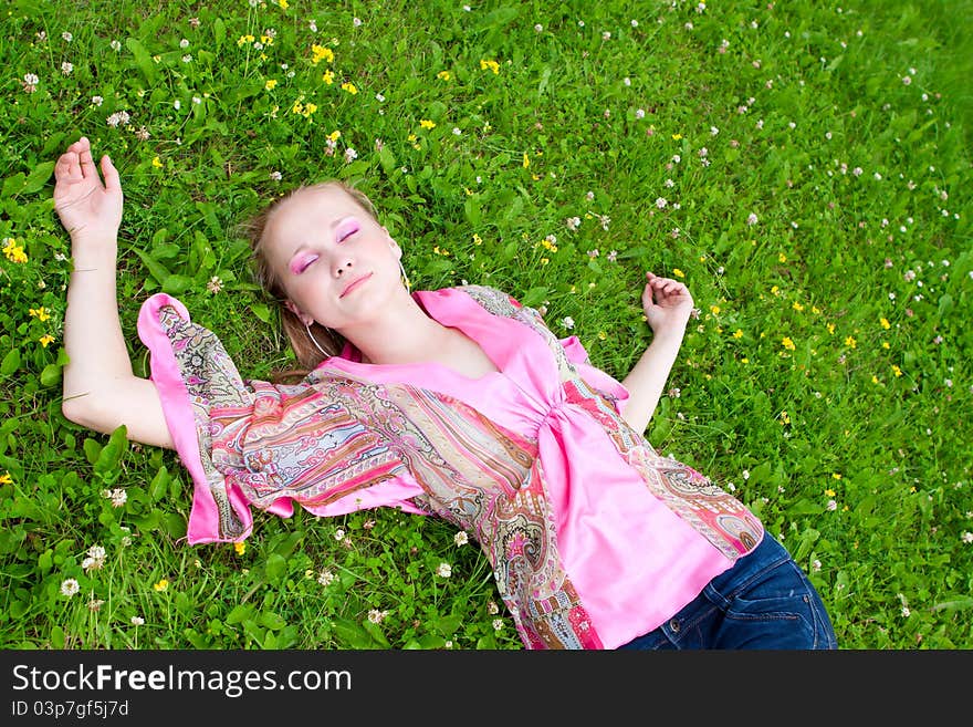 Portrait of a young woman on the meadow