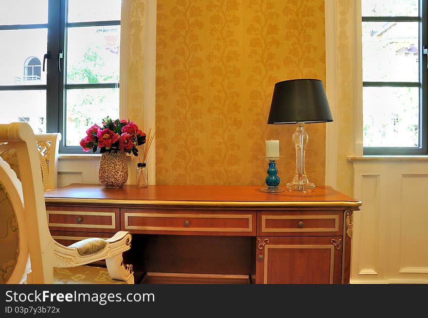 Secretaire and chair in schoolroom, under bright windows in home, shown as bright and quiet environment at home for study and reding. Secretaire and chair in schoolroom, under bright windows in home, shown as bright and quiet environment at home for study and reding.