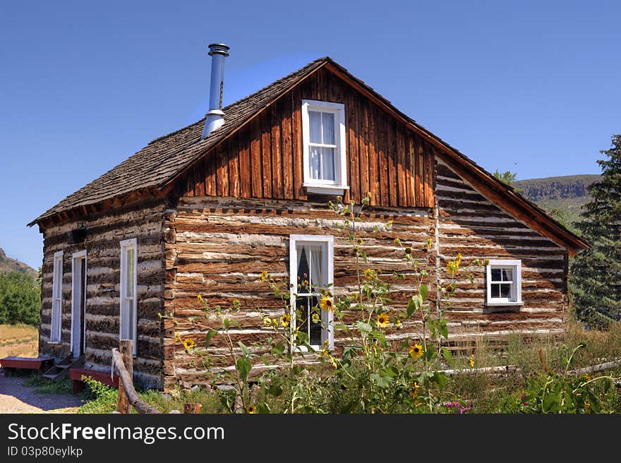 Authentic log cabin circa 1800s in a beautiful summer's day in 2011. Authentic log cabin circa 1800s in a beautiful summer's day in 2011