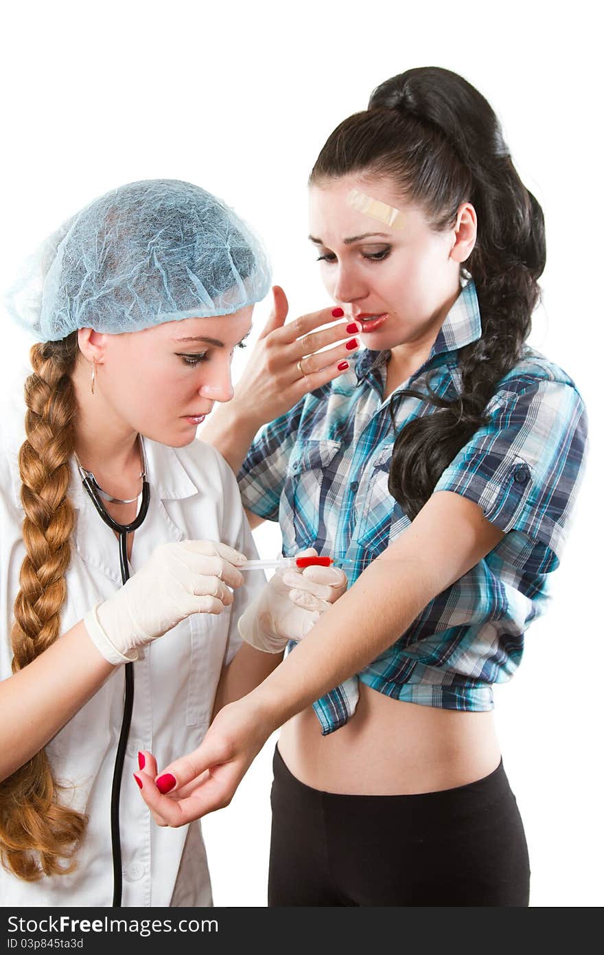 doctor in a white medical coat with a stethoscope takes blood from the vein in patient on white background. doctor in a white medical coat with a stethoscope takes blood from the vein in patient on white background