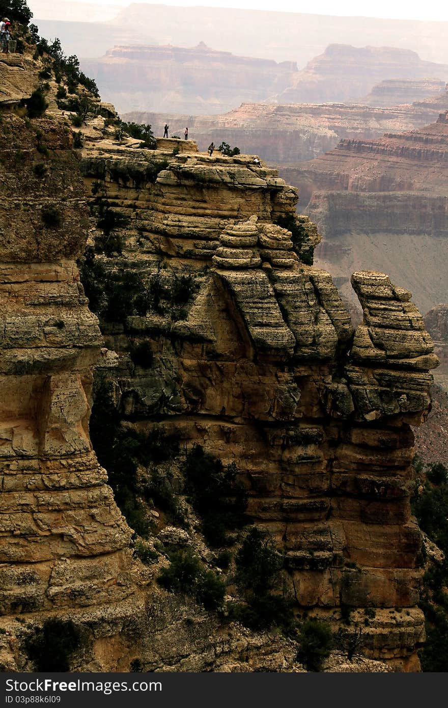 A picture of the Grand Canyon. People standing at an overlook.