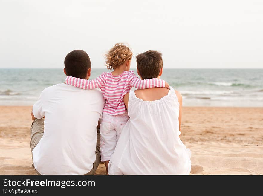 Mother and father on the beach with baby. Mother and father on the beach with baby