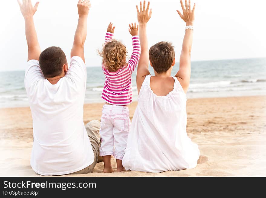 Family With Hand Up Are Looking The Ocean