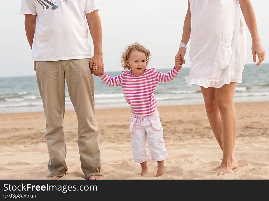 Father mather and child are looking the ocean. Father mather and child are looking the ocean