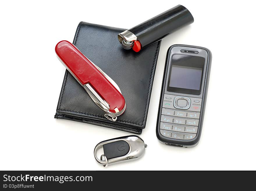 Closeup shot of wallet, folding knife, cell phone, lighter, and key chain flash light. Closeup shot of wallet, folding knife, cell phone, lighter, and key chain flash light.