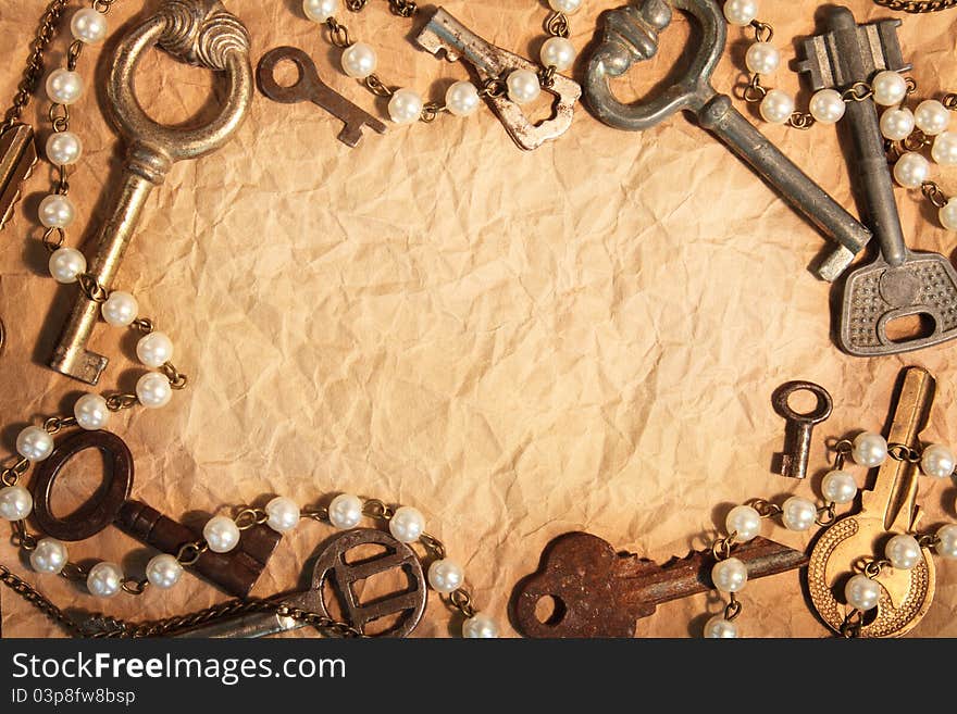 Blank sheet of crumpled paper, framed different old keys. Blank sheet of crumpled paper, framed different old keys