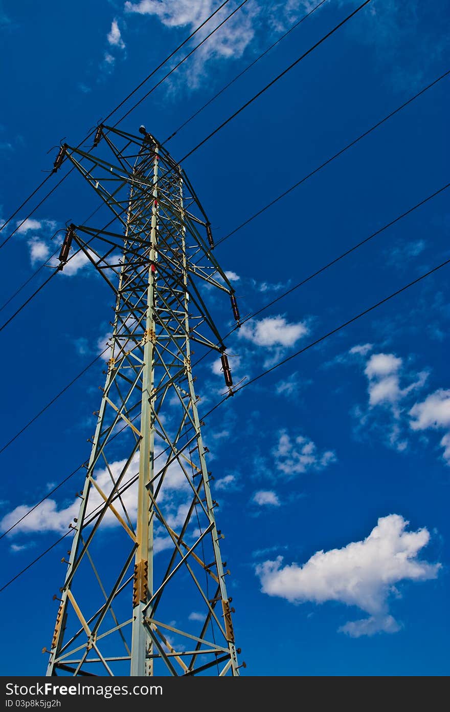 Electric mast in the field at sunny weather