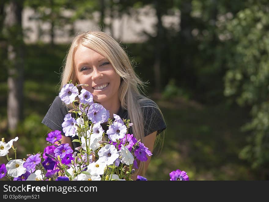 Girl with flowers on a natural green background. Girl with flowers on a natural green background