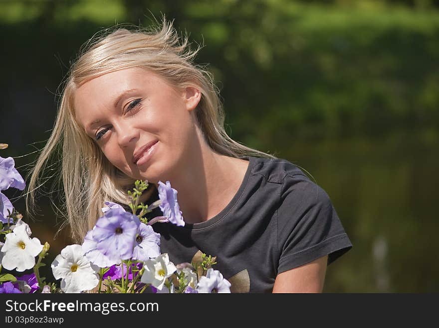 Girl with flowers on a natural green background. Girl with flowers on a natural green background