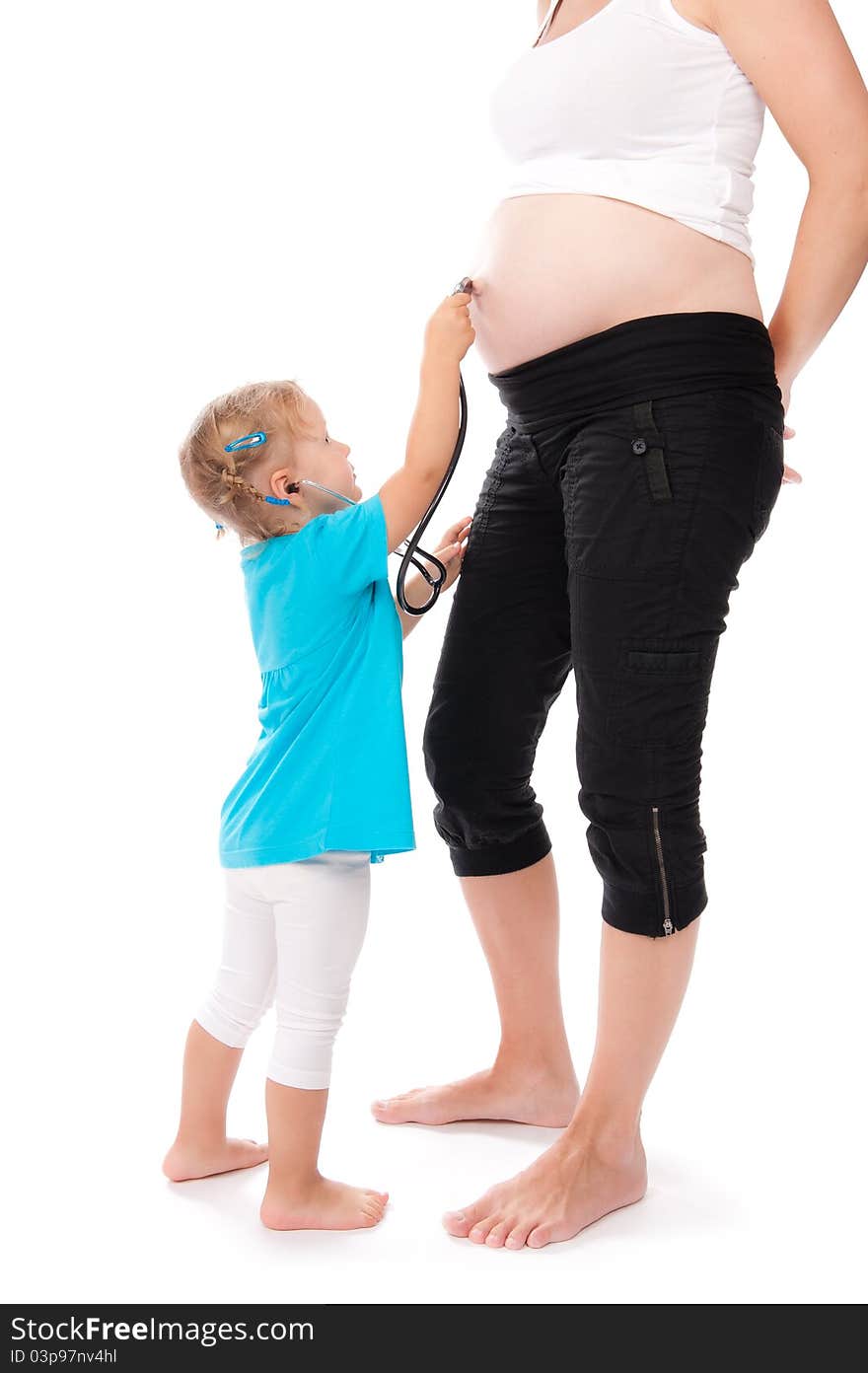 Child is listening pregnant belly with stethoscope