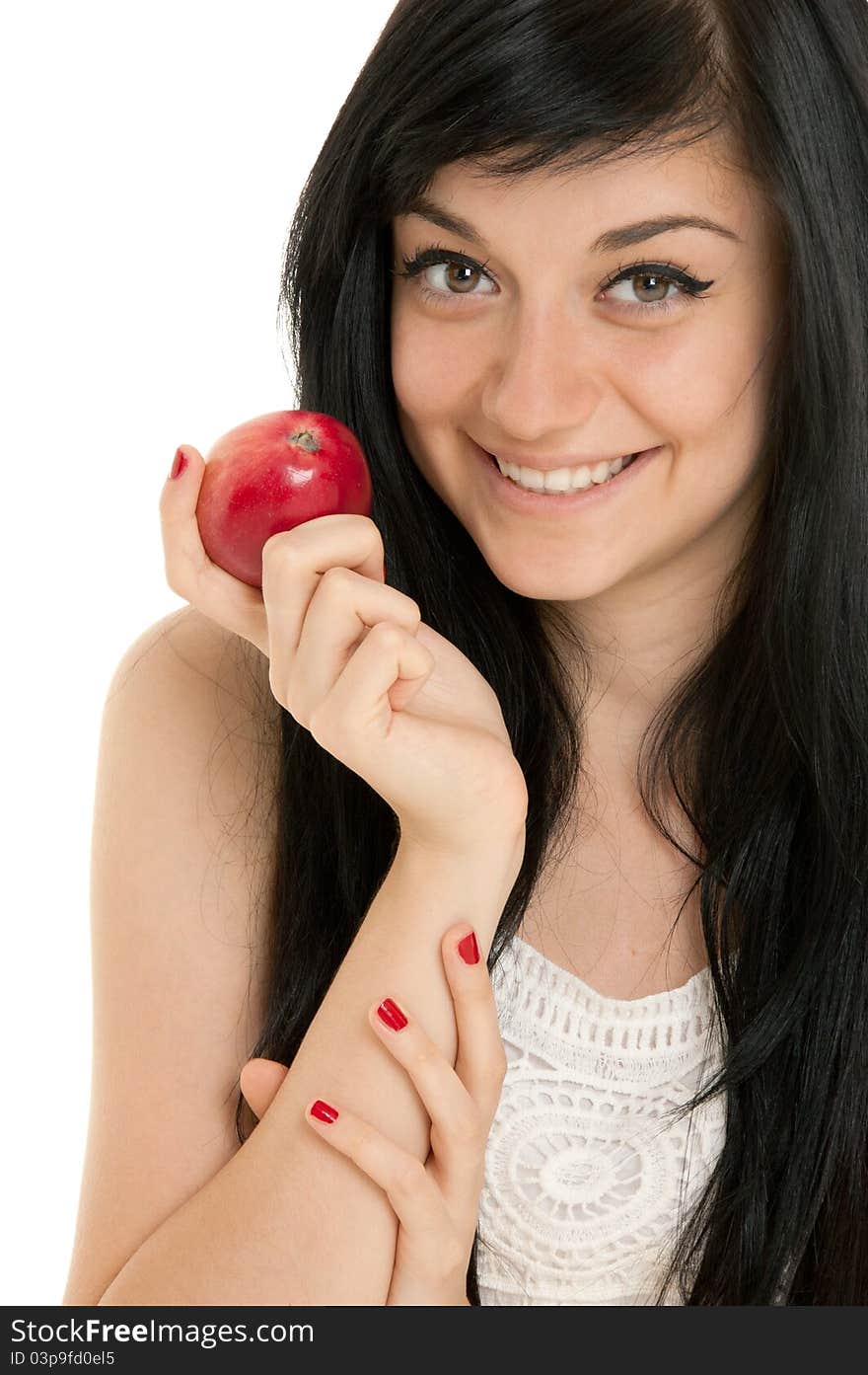 Beautiful brunette girl wearing a white dress putting red apple and standing on white background. Beautiful brunette girl wearing a white dress putting red apple and standing on white background