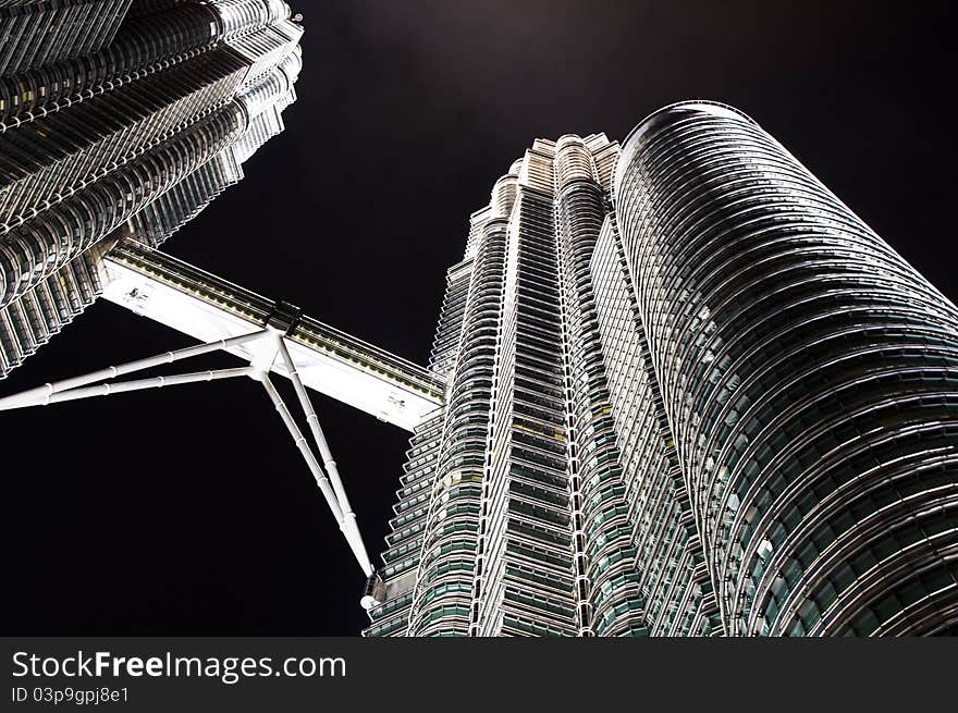 A night view of the Petronas Twin Towers in Kuala Lumpur, Malaysia, Asia. The towers feature a skybridge between the two towers on 41st and 42nd floors, which is the highest 2-story bridge in the world. It is not attached to the main structure, but is instead designed to slide in and out of the towers to prevent it from breaking, as the towers sway several feet in towards and away from each other during high winds. A night view of the Petronas Twin Towers in Kuala Lumpur, Malaysia, Asia. The towers feature a skybridge between the two towers on 41st and 42nd floors, which is the highest 2-story bridge in the world. It is not attached to the main structure, but is instead designed to slide in and out of the towers to prevent it from breaking, as the towers sway several feet in towards and away from each other during high winds.