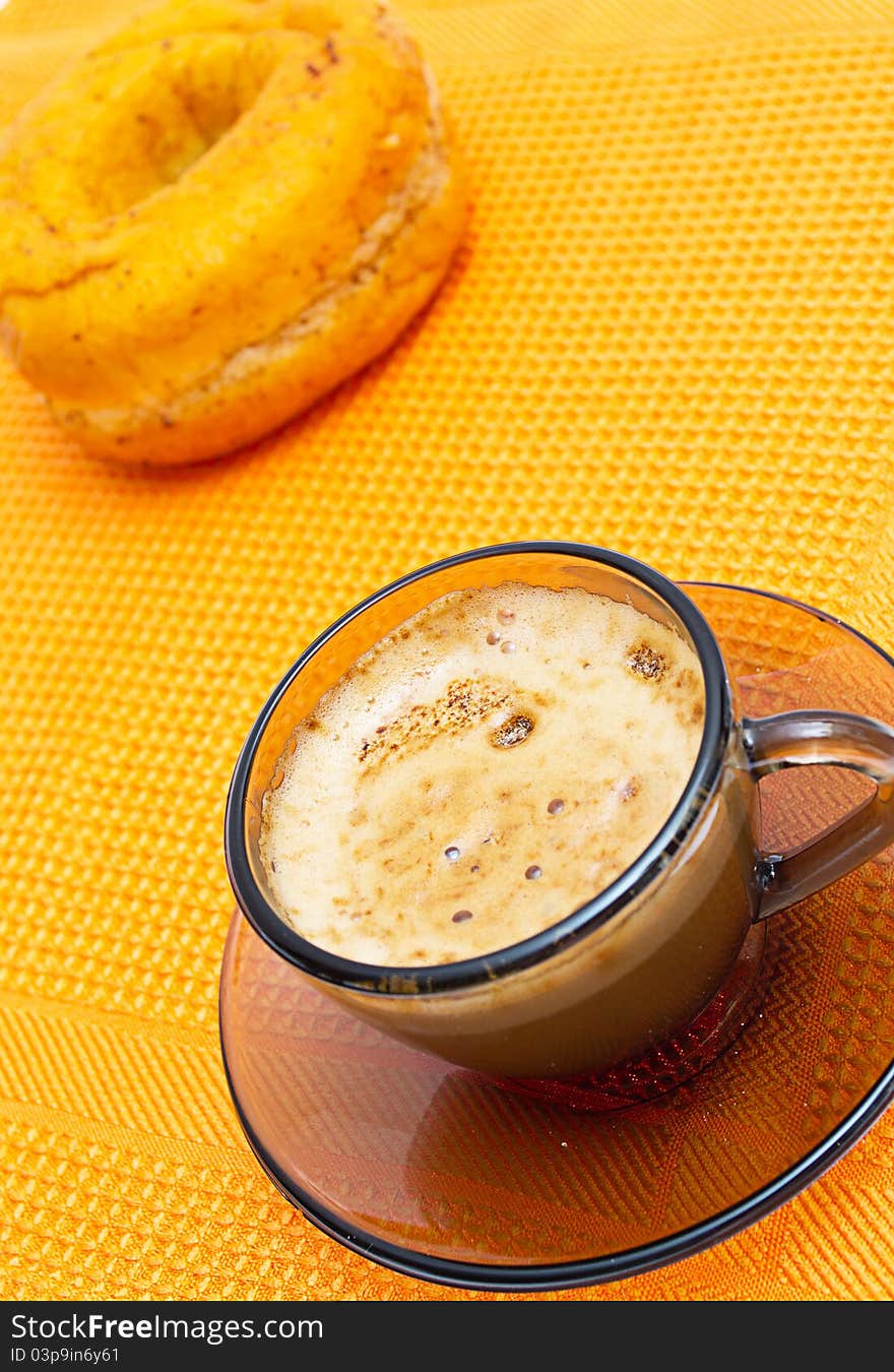 Cappuccino, donut, on orange napkin. Cappuccino, donut, on orange napkin