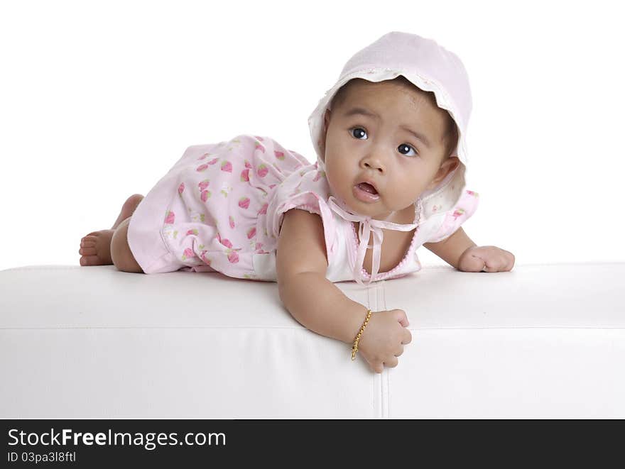 Baby girl on white sofa.