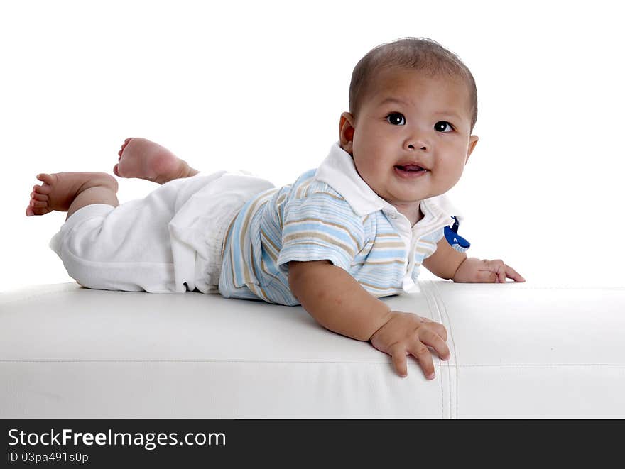 Baby boy on white sofa by studio lighting in my home. Baby boy on white sofa by studio lighting in my home.