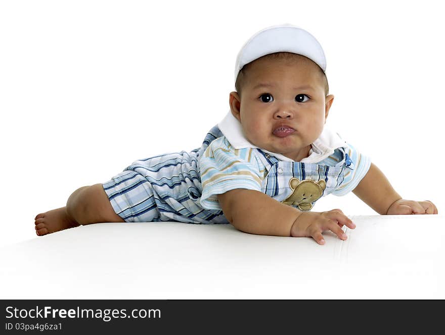 Baby boy on white sofa by studio lighting in my home. Baby boy on white sofa by studio lighting in my home.