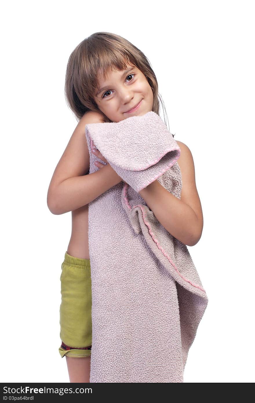 Little girl, holding pink blanket, studio shot