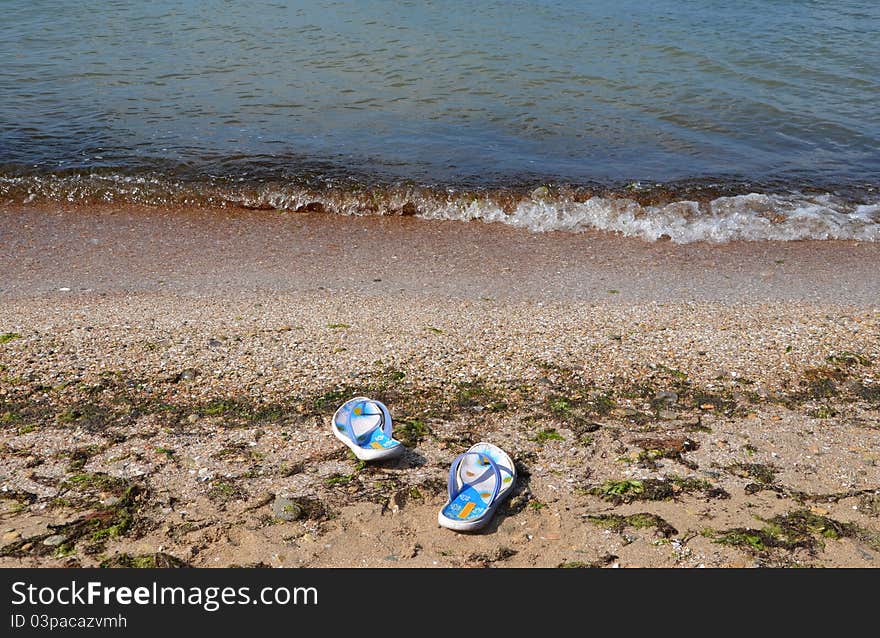 Beachfront shoes on sand in beach