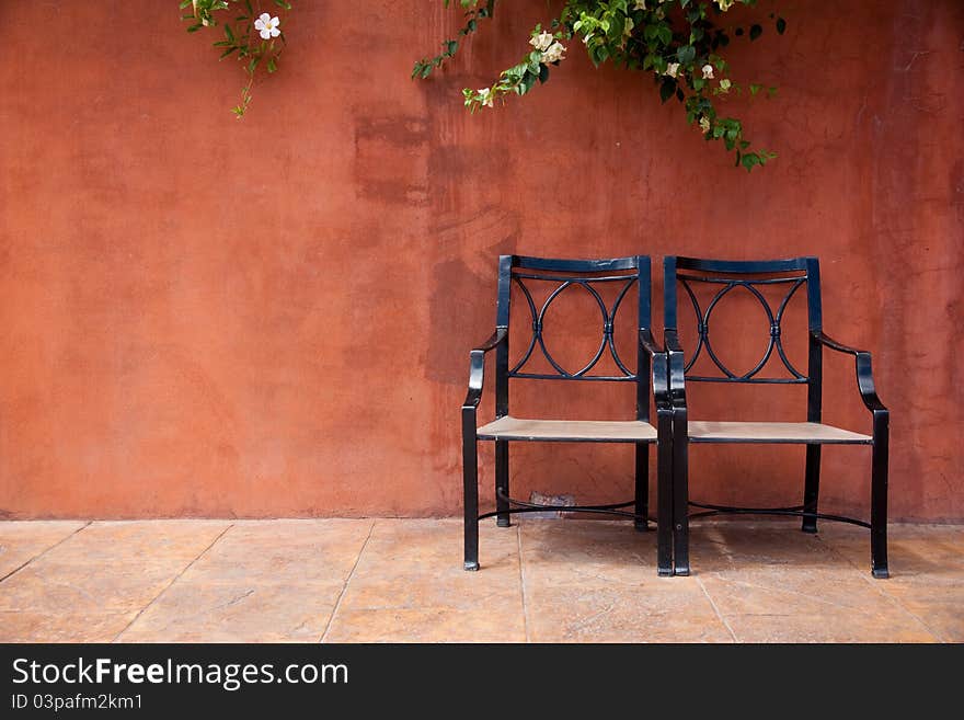 Brown background with a climber and chair