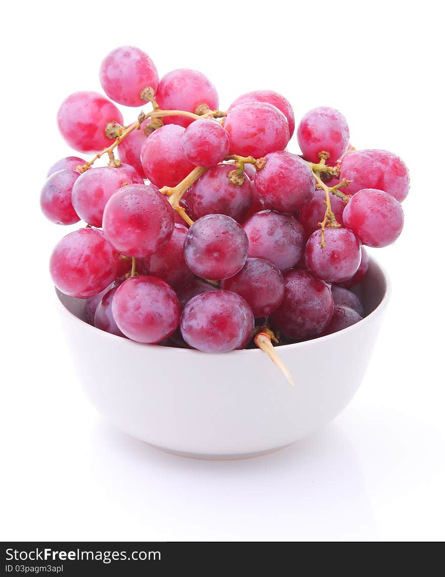 Image of red grape in bowl isolated on white