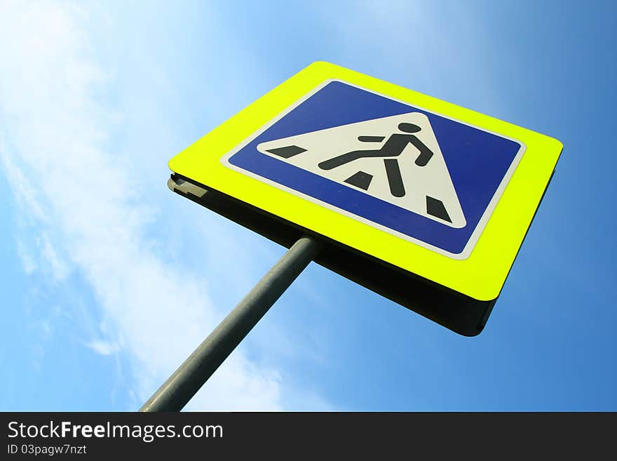 Image of pedestrian crossing sign against sky