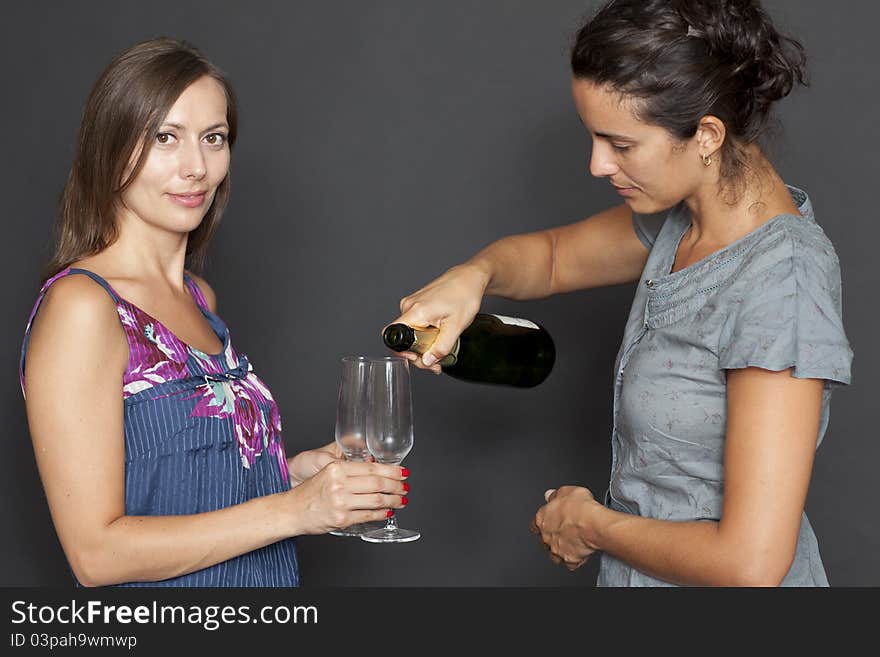 Two attractive women drinking champagne. Two attractive women drinking champagne