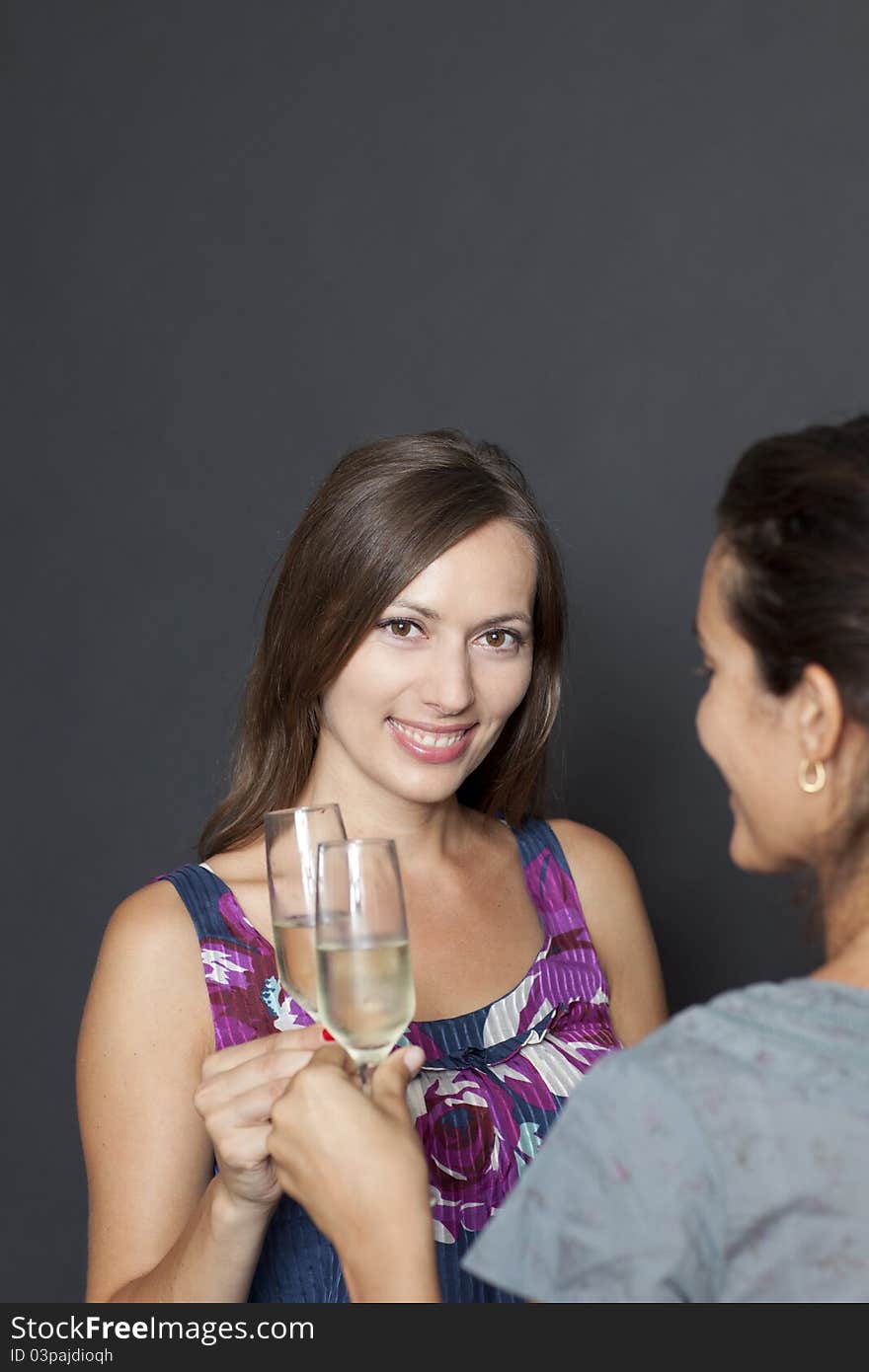 Two attractive women drinking champagne. Two attractive women drinking champagne