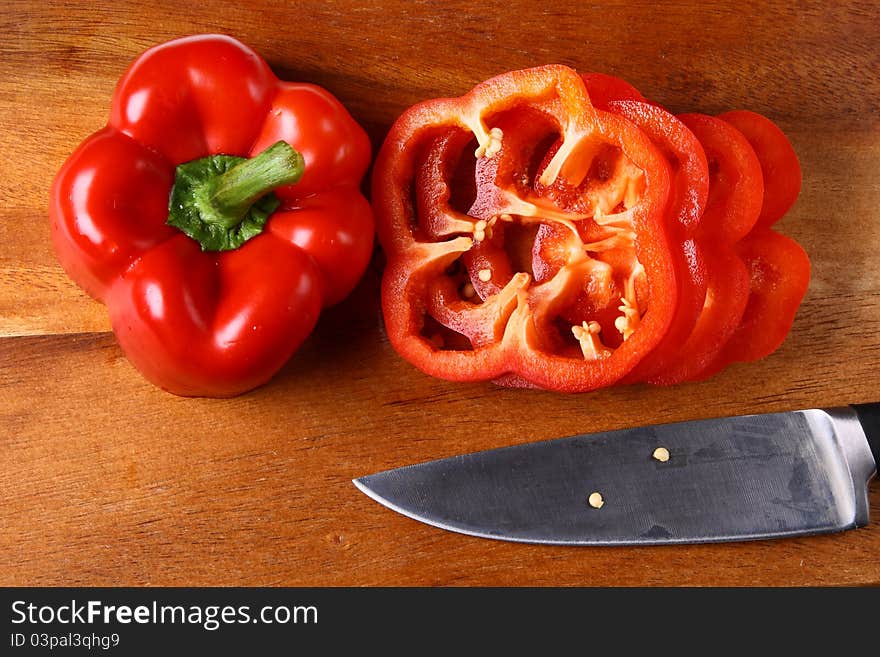 Image of sweet red pepper sliced on hardboard