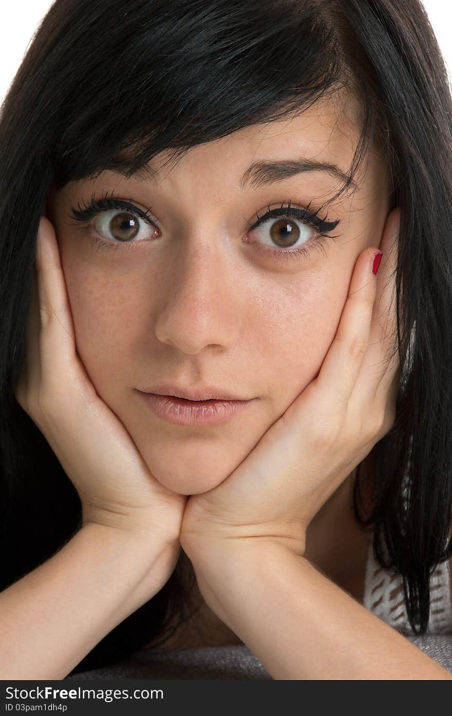 Beautiful brunette girl with a surprised expression on her face  close-up