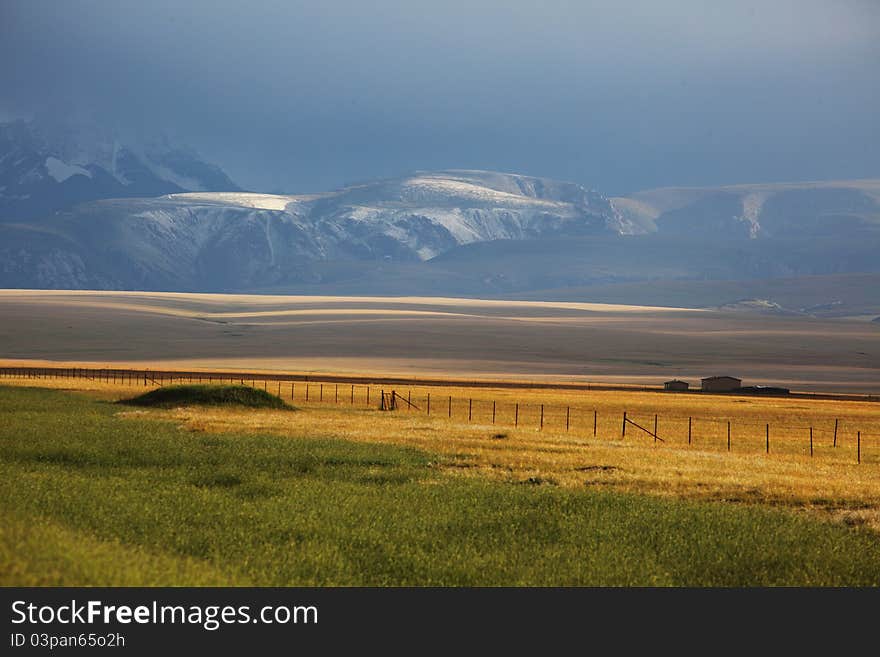 Tianshan many ranch under the sun through the clouds. Tianshan many ranch under the sun through the clouds