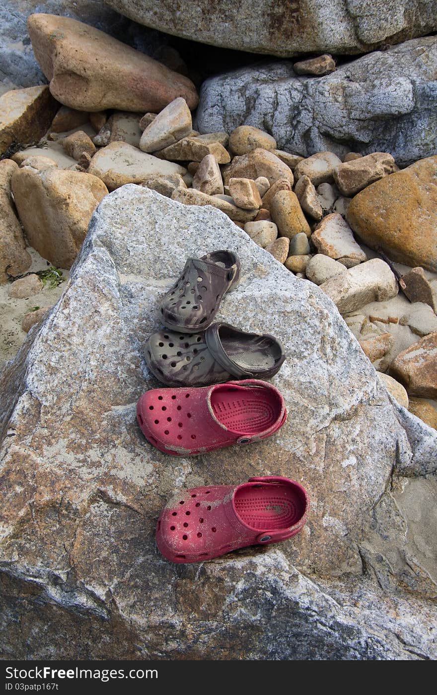 Beach shoes on a rock means it's summer at last. Beach shoes on a rock means it's summer at last