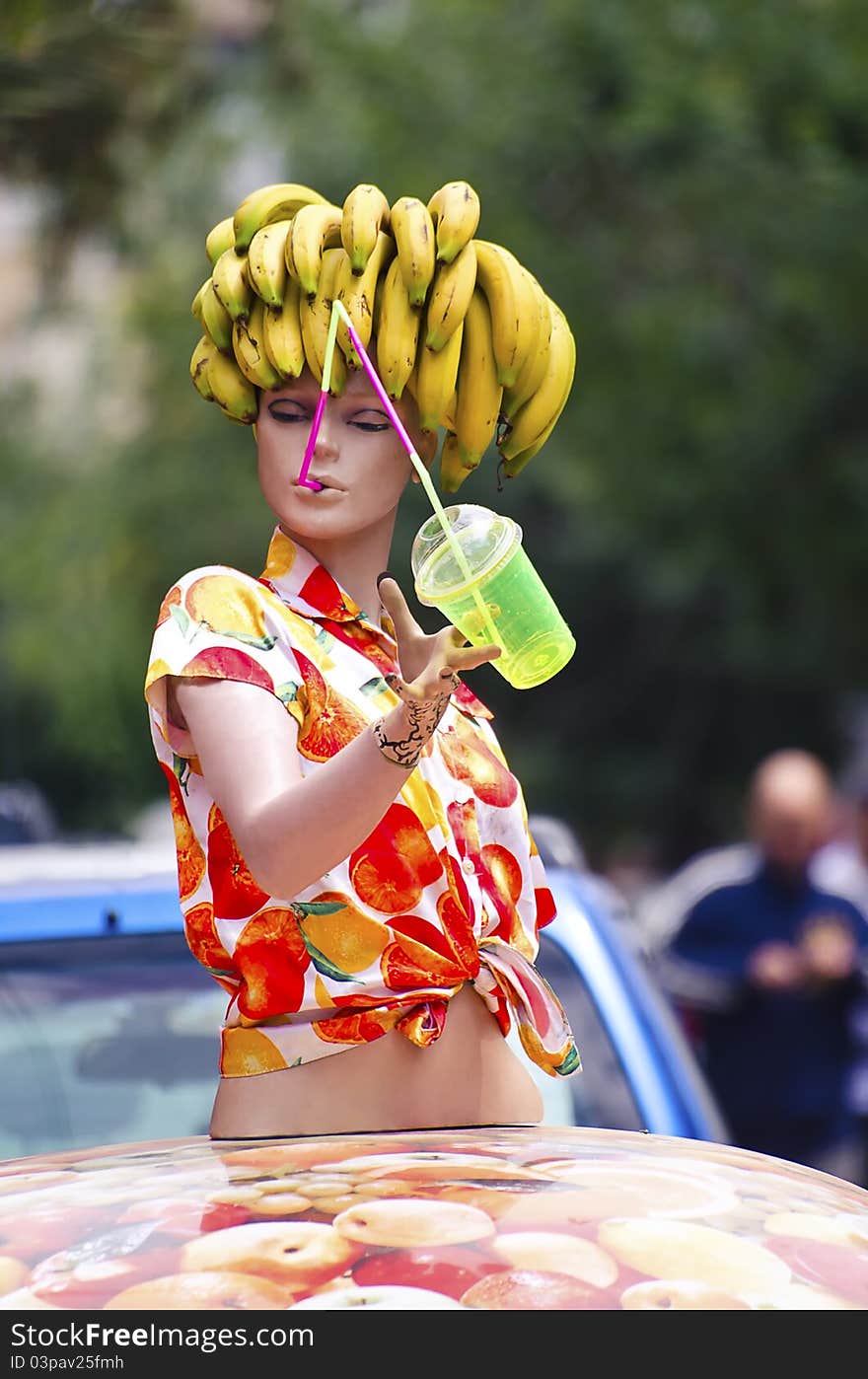 A doll with a bunch of banana on the head. A doll with a bunch of banana on the head