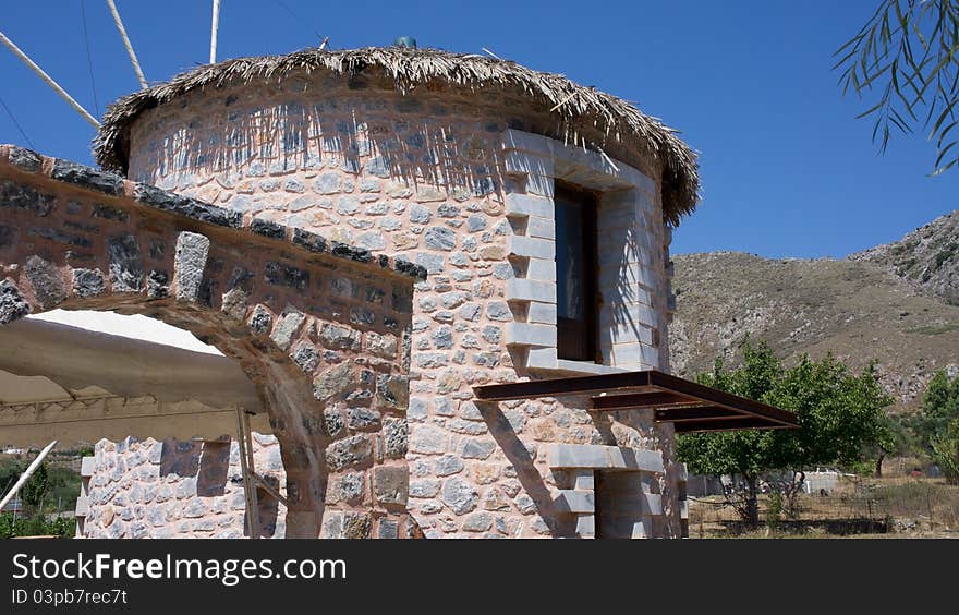 Old wind mill against a blue sky.Rethymno