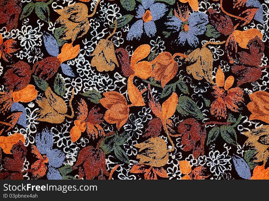 Background of old fabric with autumnal colors and flowers, leafs and ornaments. Background of old fabric with autumnal colors and flowers, leafs and ornaments