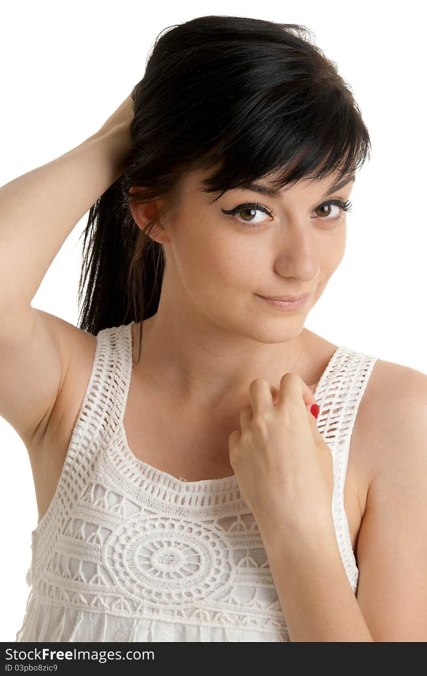 Beautiful brunette girl wearing a white dress standing on white background