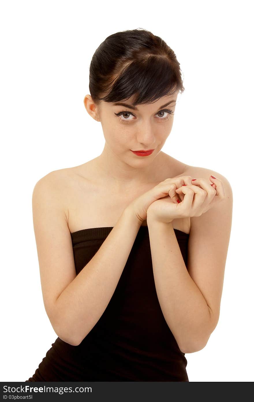 Beautiful brunette girl wearing a black dress standing on the floor on a white background