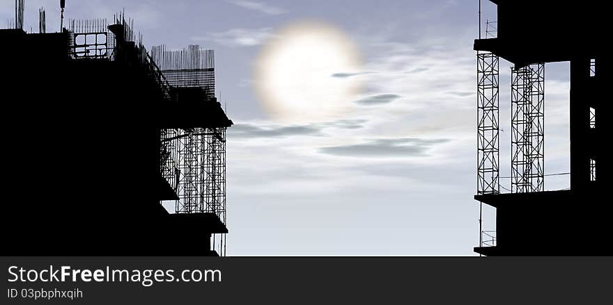 Silhouette of construction, construction equipment and elements of the building under construction on the sky background